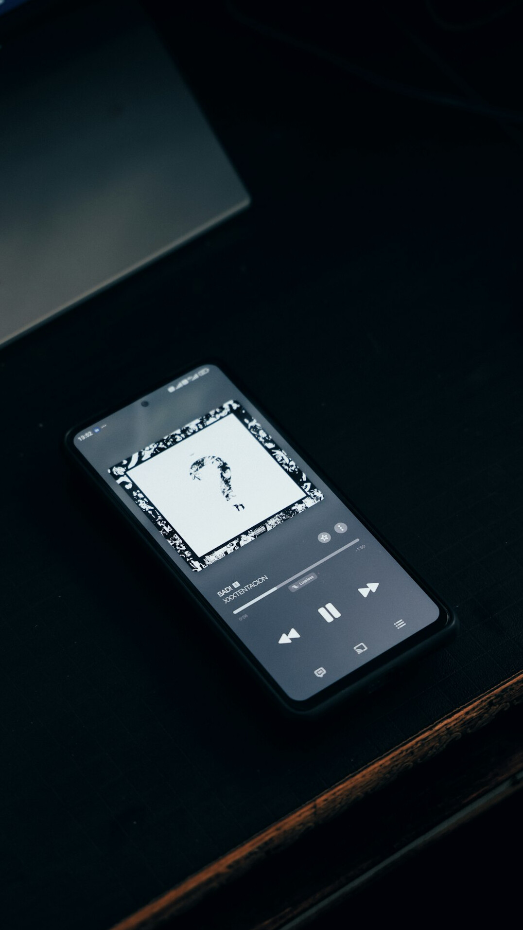 Smartphone showing app icons on a table
