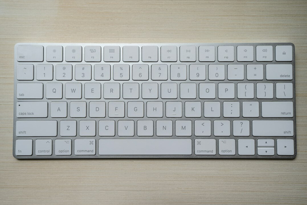 Hands typing on a laptop keyboard while editing a story