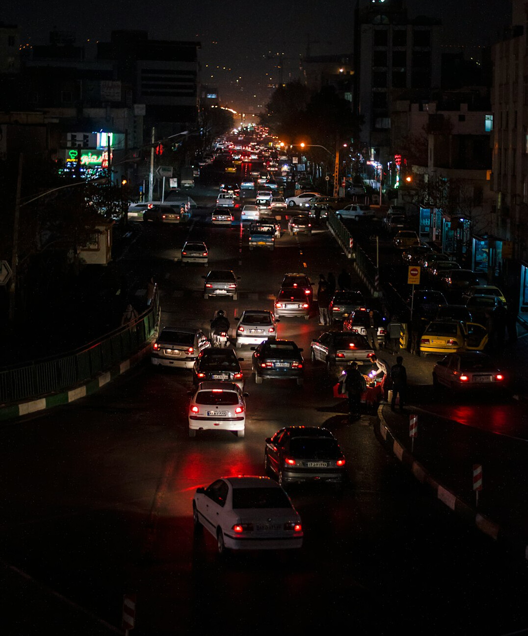 Busy city street in the evening with traffic lights